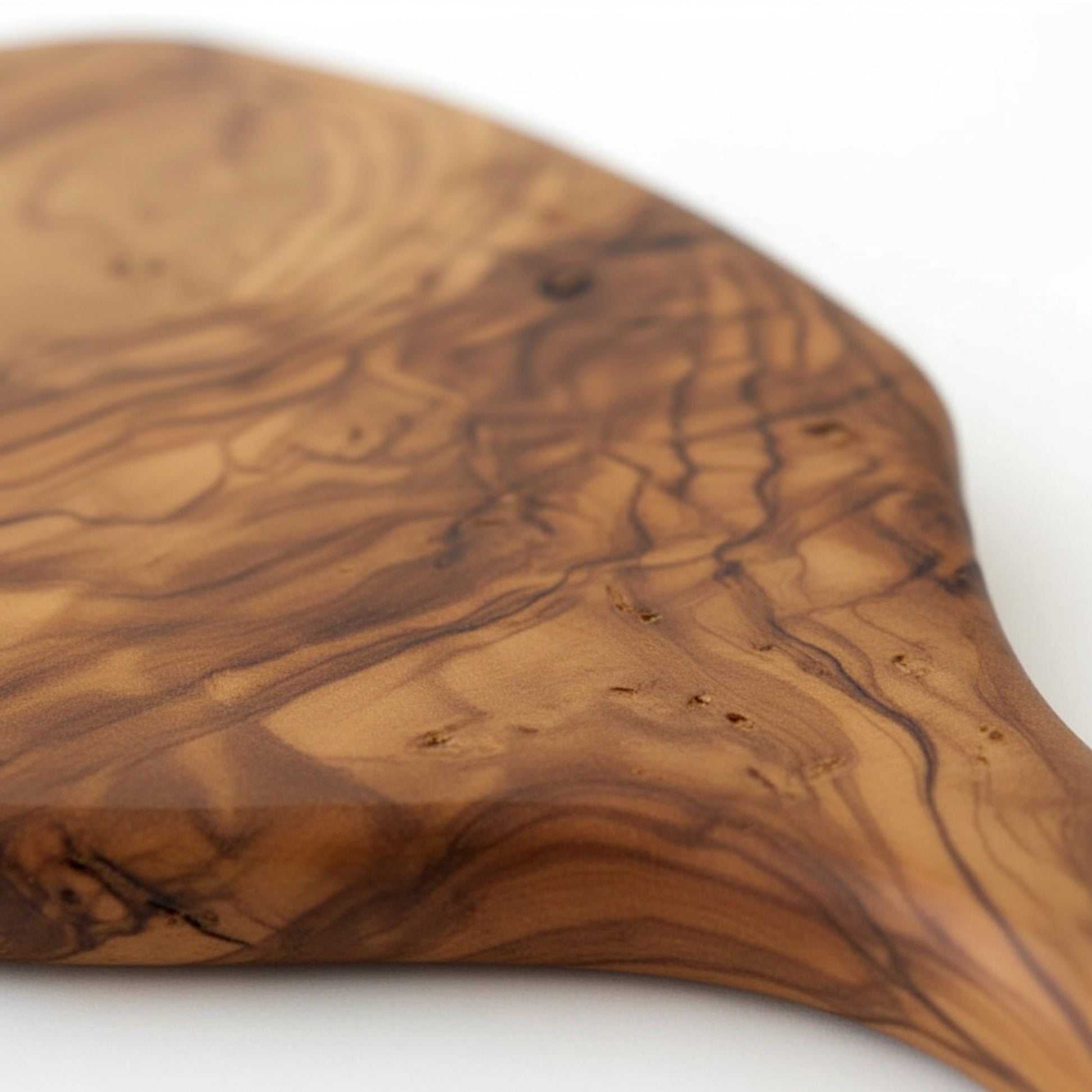 Olive wood serving paddle board for cheese and charcuterie.