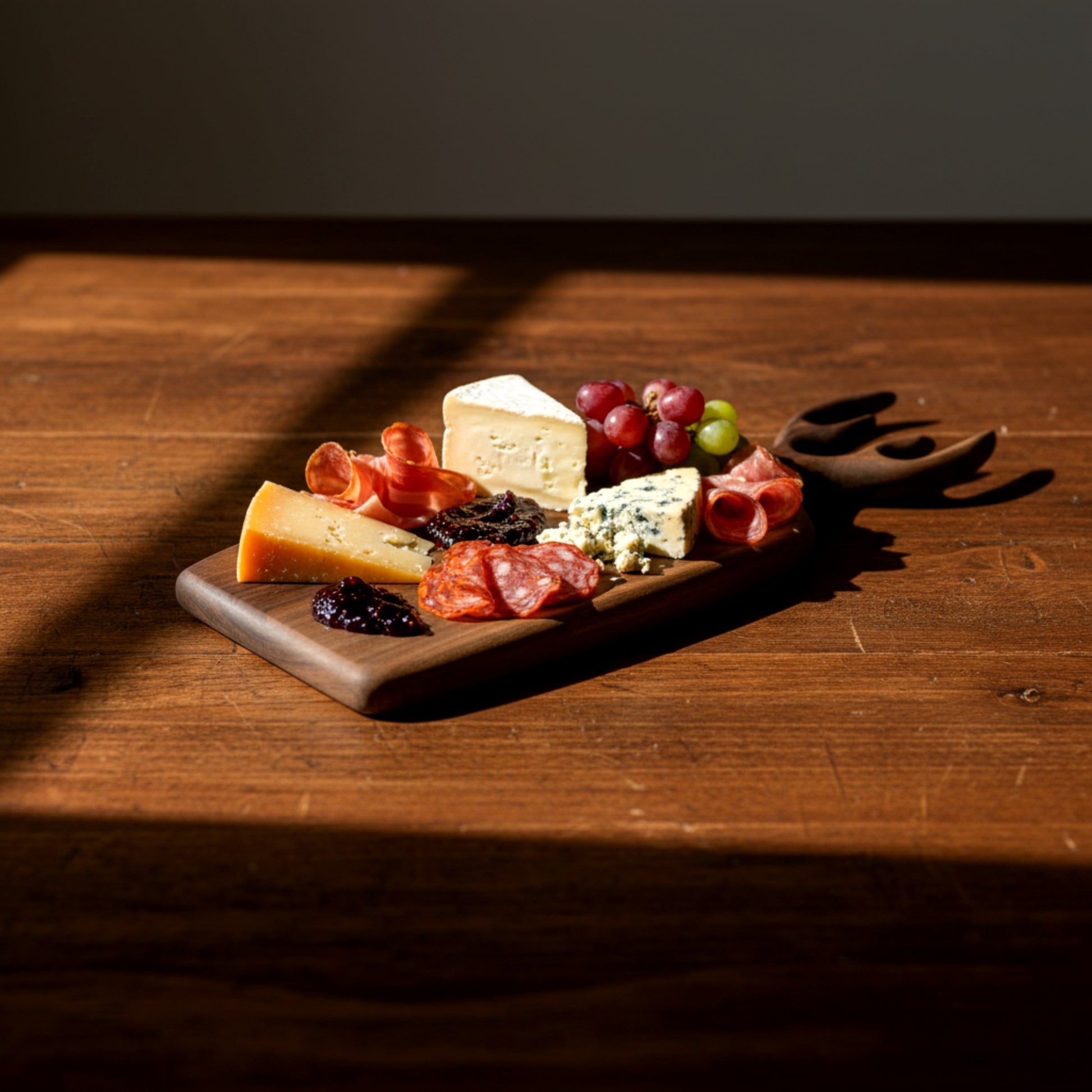 Hand carved walnut wood serving board with antler handle.