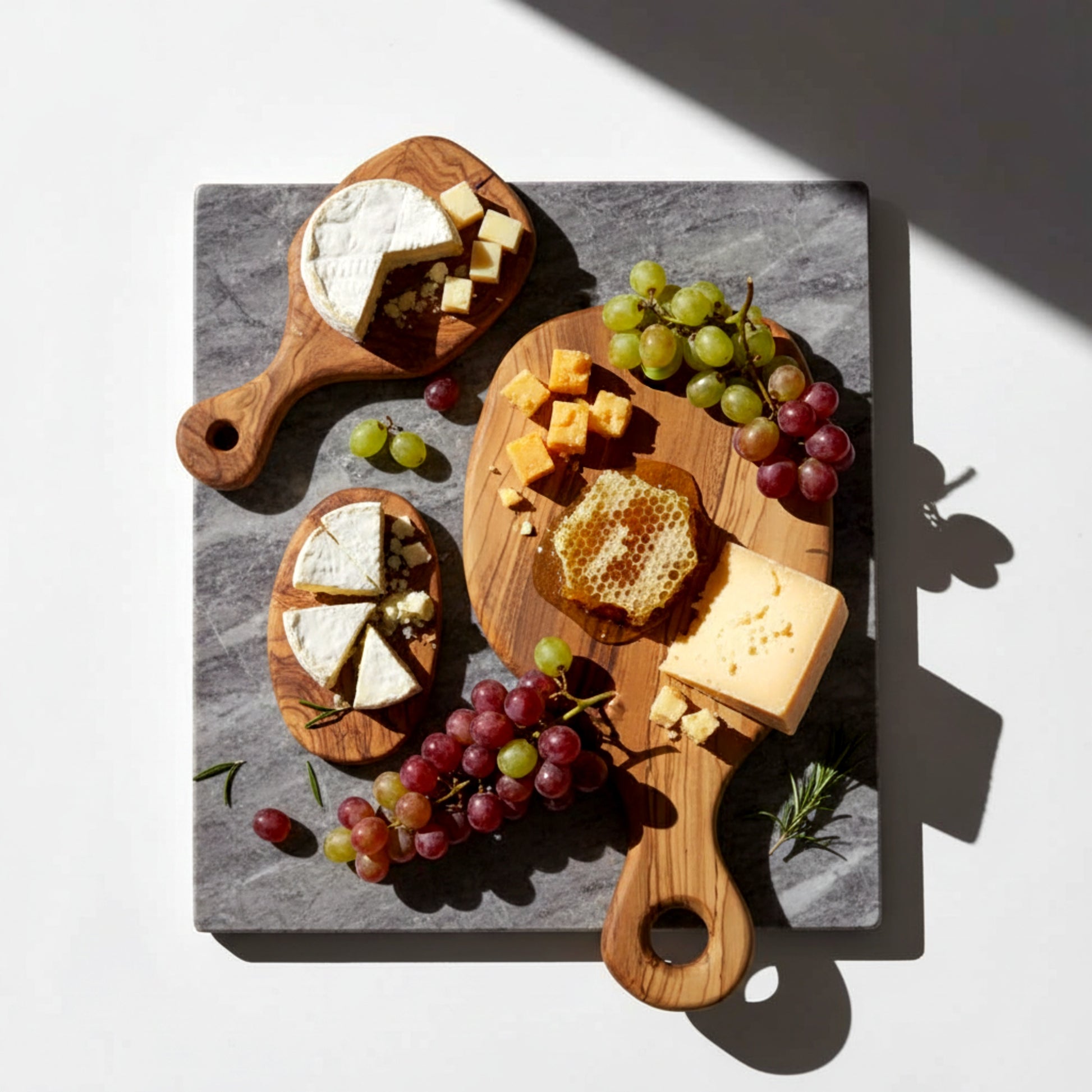 Olive wood serving paddle board for cheese and charcuterie.