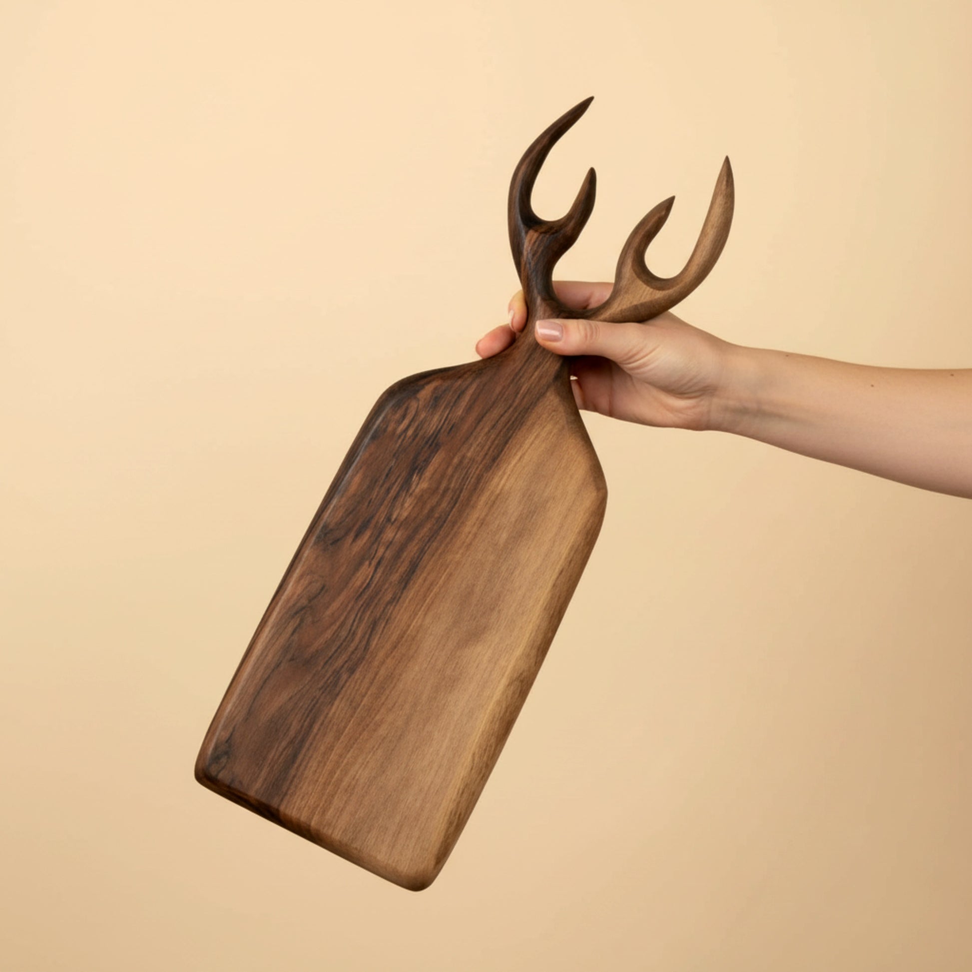 Hand carved walnut wood serving board with antler handle.