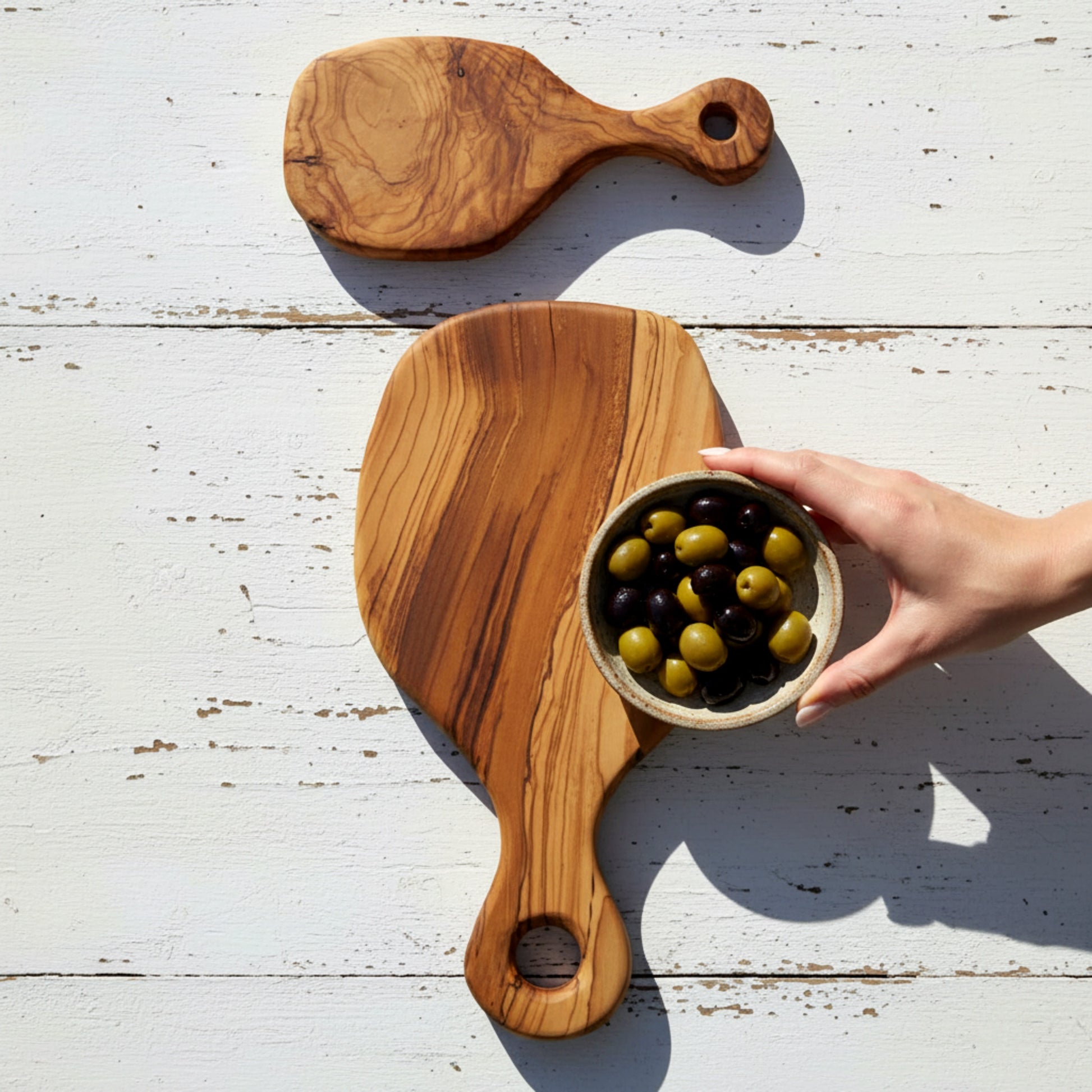 Olive wood serving paddle board for cheese and charcuterie.