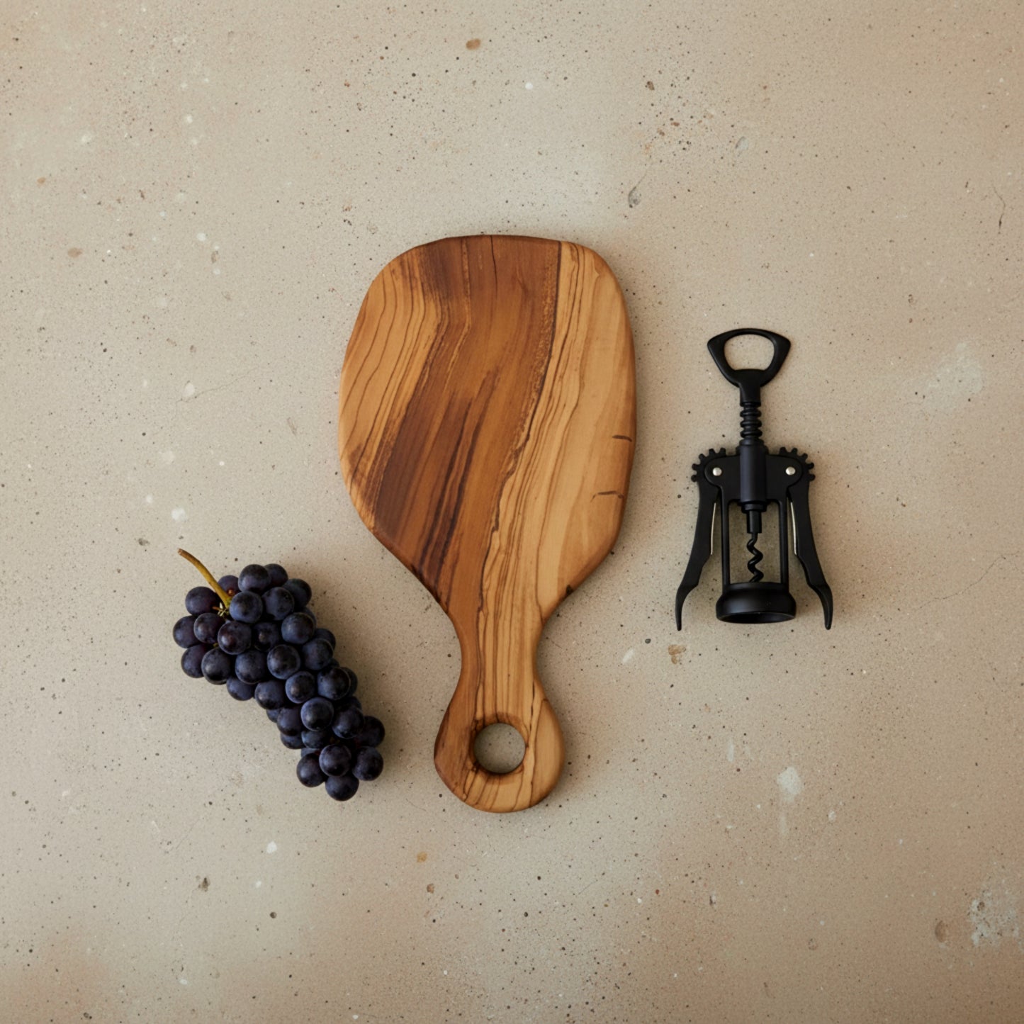 Olive wood serving paddle board for cheese and charcuterie.